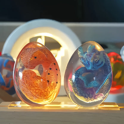 Transparent Dragon Egg Figurine in Red or Green with Oval Resin-Style Display Form Pictured