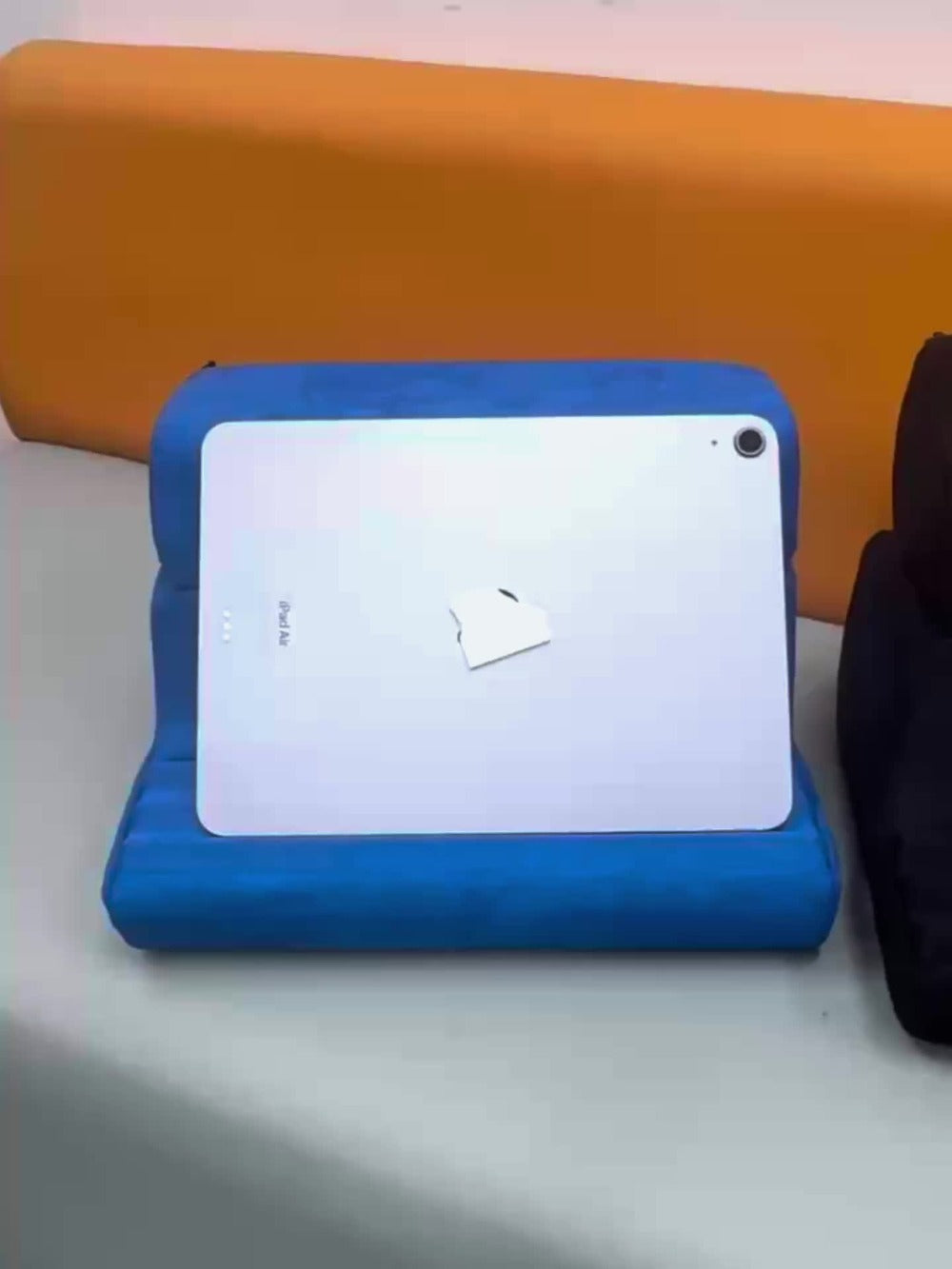 Soft Foldable Tablet Pillow Stand in Black or Blue with Three Viewing Faces, Storage Pockets and 242 × 186 × 290 mm Label