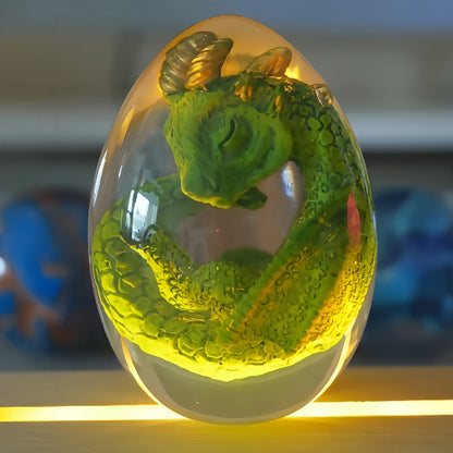 Transparent Dragon Egg Figurine in Red or Green with Oval Resin-Style Display Form Pictured