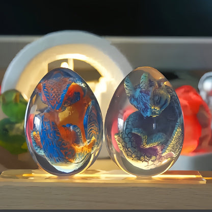 Transparent Dragon Egg Figurine in Red or Green with Oval Resin-Style Display Form Pictured